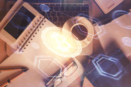 Double exposure of blockchain theme hologram over table with phone. Top view. Crypto technology...