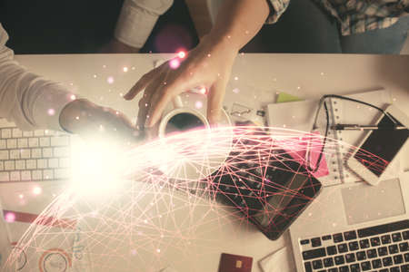 Double exposure of man and woman working together and social network theme hologram drawing. Computer background. connecting concept. Top View.の写真素材