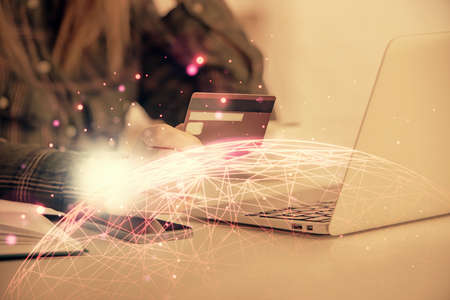 Multi exposure of woman on-line shopping holding a credit card and social network theme drawing....
