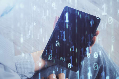 Double exposure of mans hand holding and using a digital device and data theme drawing. Technology...