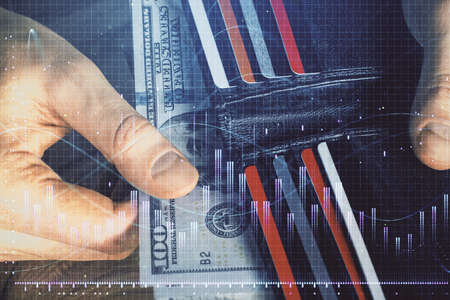 Multi exposure of forex graph drawing hologram and USA dollars bills and man hands. Technical...