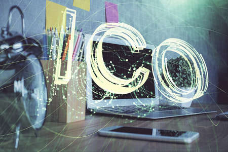 Double exposure of blockchain and crypto economy theme hologram and table with computer background. Concept of bitcoin cryptocurrency.の写真素材