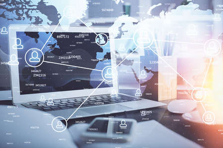 Computer on desktop with social network hologram. Double exposure. Concept of international people...