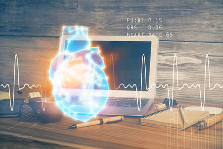 Desktop computer background and heart drawing. Double exposure. Medical study and healthcare...
