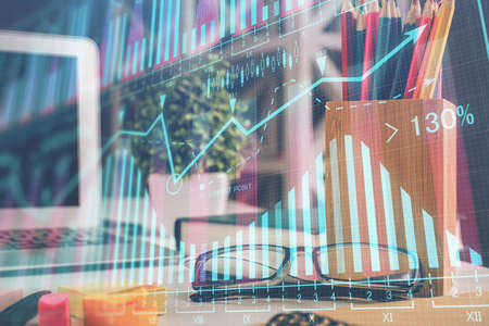 Financial chart hologram with glasses on the table background. Concept of business. Double exposure.の写真素材