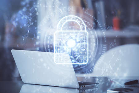 Double exposure of desktop with computer and lock icon hologram. Concept of data safety.の写真素材