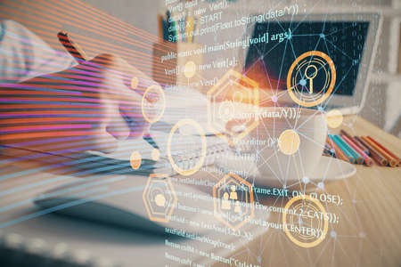 Double exposure of hands making notes with digital coding icons. Computer learning concept.の写真素材