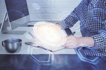 Blockchain theme hud with man working on computer on background. Concept of crypto chain. Double exposure.の写真素材