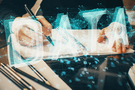 Double exposure of writing hands on background with data solution hologram on front. Technology concept. Close upの写真素材
