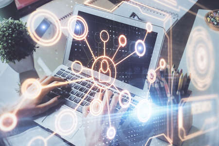 Media network theme hologram with man working on computer on background. Concept of internet...