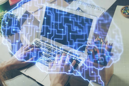 Businessman with computer background with brain theme hologram. Concept of brainstorm. Multi...