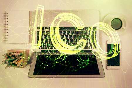 Blockchain theme hologram drawings over computer on the desktop background. Top view. Double...