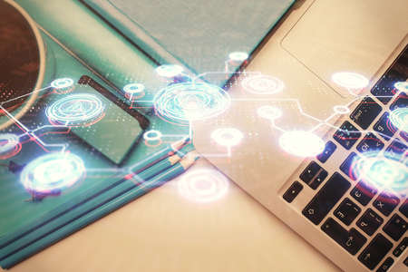 Social network hologram drawings over computer on the desktop background. Top view. Multi exposure....