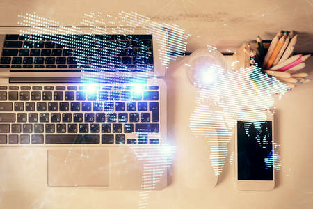 Social network hologram drawings over computer on the desktop background. Top view. Multi exposure....