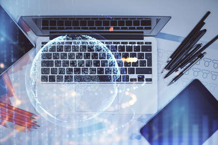 Double exposure of map hologram drawing over study table background with computer. Concept of...