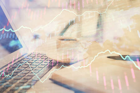Double exposure of financial chart drawing and desktop with coffee and items on table background....