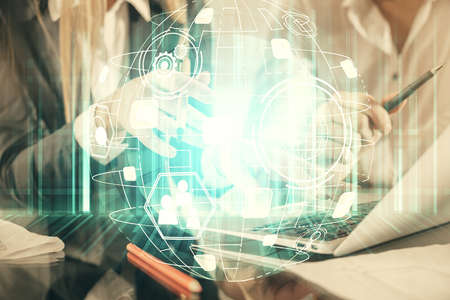 Double exposure of man and woman working together and social network theme hologram drawing. People...