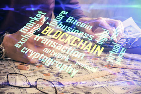 Double exposure of man's hands holding and using a phone and crypto currency blockchain theme drawing.の写真素材