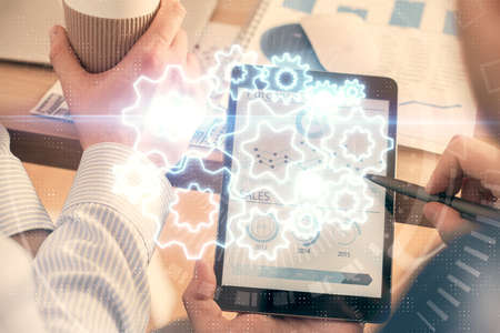 Double exposure of man's hands holding and using a phone and international business theme drawing.