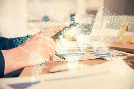 Double exposure of man's hands holding and using a phone and international business theme drawing.