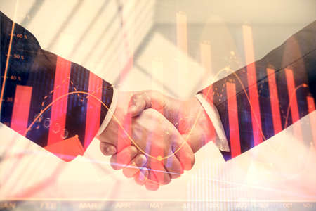 Double exposure of forex graph hologram and handshake of two men. Stock market concept.