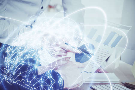 Double exposure of Man writing in notepad with business icons on background. Concept of...