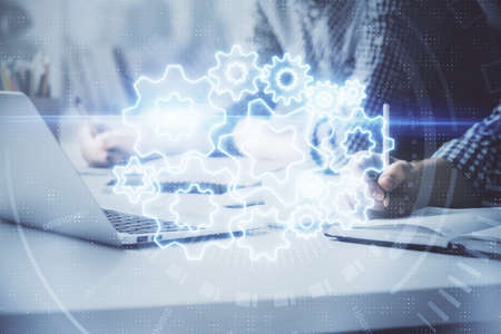 Multi exposure of businessman working on laptop on background. International business hologram in...