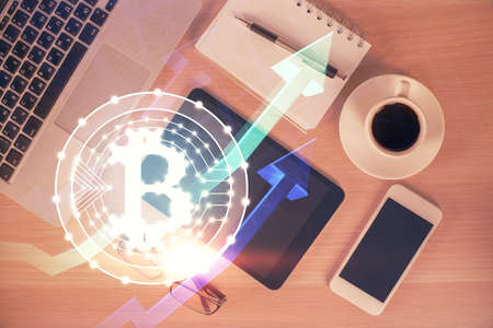 Double exposure of blockchain theme hologram over table with phone. Top view. Crypto technology...