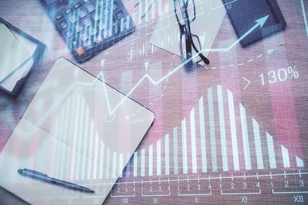 Double exposure of forex graph drawing and work table top veiw. Concept of financial analysis.