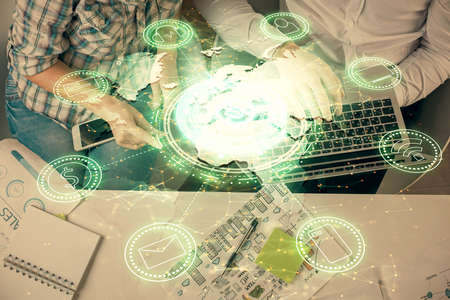 Double exposure of man and woman working together and social network theme hologram drawing....