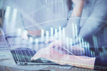 Multi exposure of woman hands typing on computer and financial chart hologram drawing. Stock market...