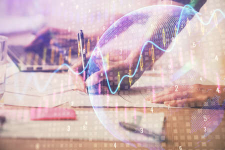 Multi exposure of woman hands typing on computer and financial chart hologram drawing. Stock market...