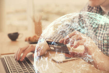 Double exposure of man hands holding a credit card and social network theme drawing. Digital finance...