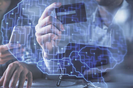 Double exposure of man and woman on-line shopping holding a credit card and brain hologram drawing....