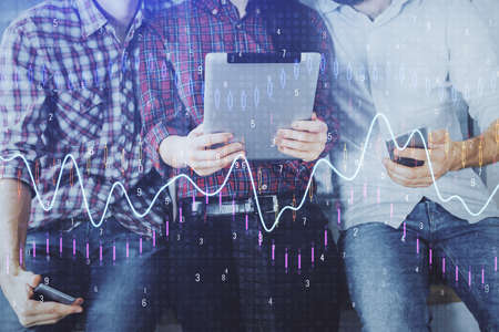 Double exposure of forex graph drawing and man and woman working together holding and using a mobile...