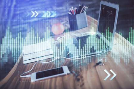 Forex market chart hologram and personal computer background. Double exposure. Concept of...