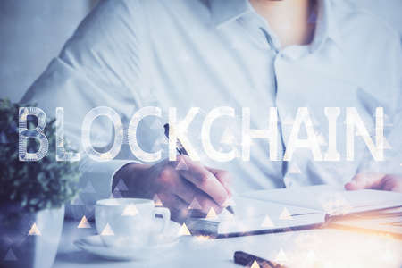Man's hands working with notes background. Cryptocurrency and finance concept. Double exposure.