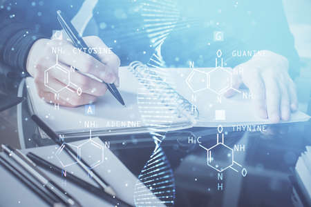 DNA theme hologram over woman's hands writing background. Concept of education. Double exposure