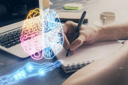 Multi exposure of writing hand on background with brain hologram. Concept of learning.