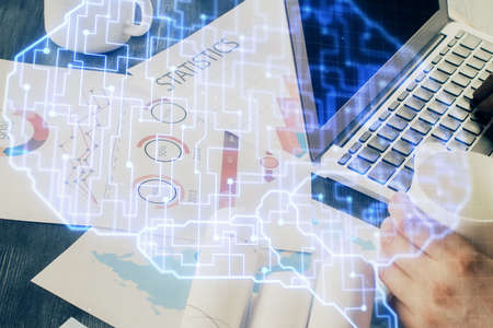 Businessman with computer background with brain theme hologram. Concept of brainstorm. Multi...