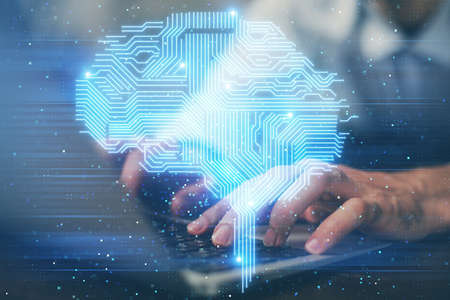 Businessman with computer background with brain theme hologram. Concept of brainstorm. Multi...