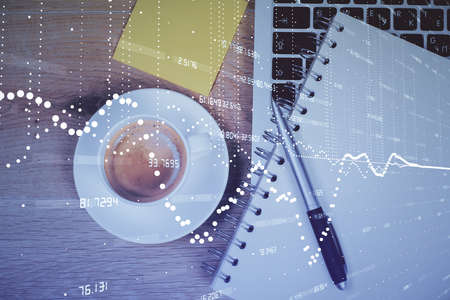 Double exposure of data drawing hologram over topview of study desk background with computer....