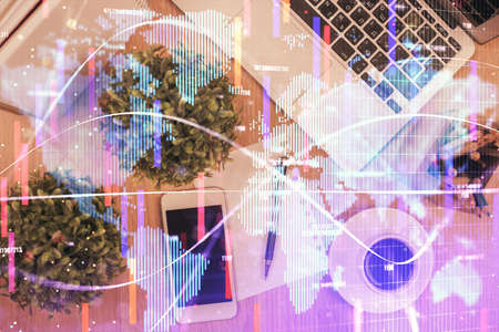 Double exposure of business theme hologram over desktop with phone. Top view. Mobile international trade connection concept.の写真素材