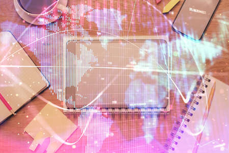 Double exposure of business theme hologram over desktop with phone. Top view. Mobile international...