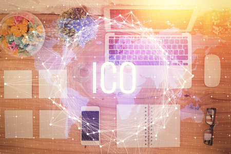 Blockchain theme hologram drawings over computer on the desktop background. Top view. Double...