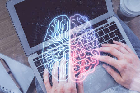 Double exposure of man's hands typing over computer keyboard and brain hologram drawing. Top view....