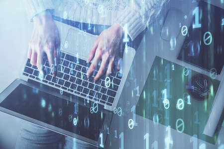 Double exposure of woman hands working on computer and data theme hologram drawing. Top View....