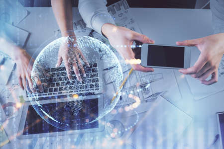 Double exposure of man and woman working together and world map hologram drawing. international...