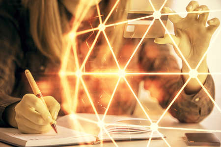 Multi exposure of woman on-line shopping holding a credit card and social network theme drawing. Relationship E-commerce concept.の写真素材