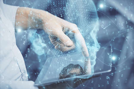 Double exposure of man's hand holding and using a digital device and brain hologram drawing. Data...